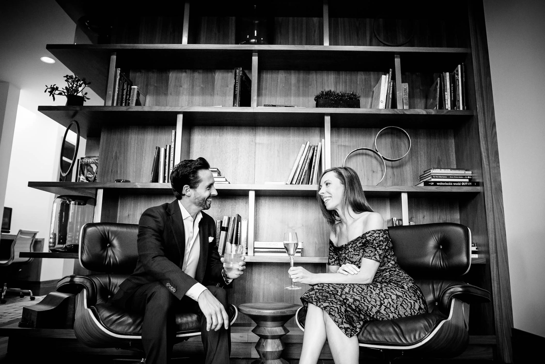 The couple shares a cocktails on the top floor of the Langham Chicago during their engagement session. 