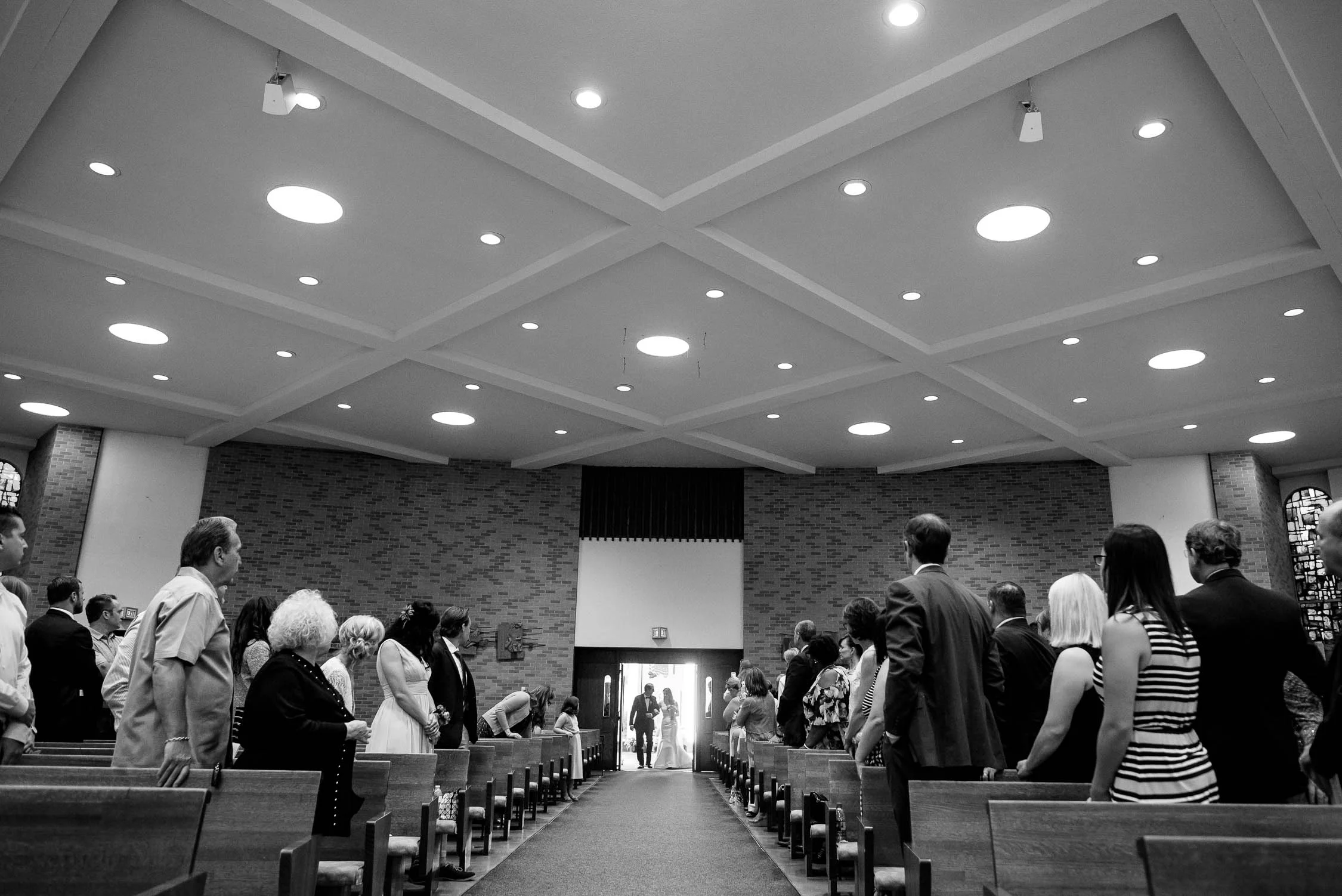 Bride walks down the aisle during her wedding ceremony at St. Barnabas in Beverly, Chicago. 