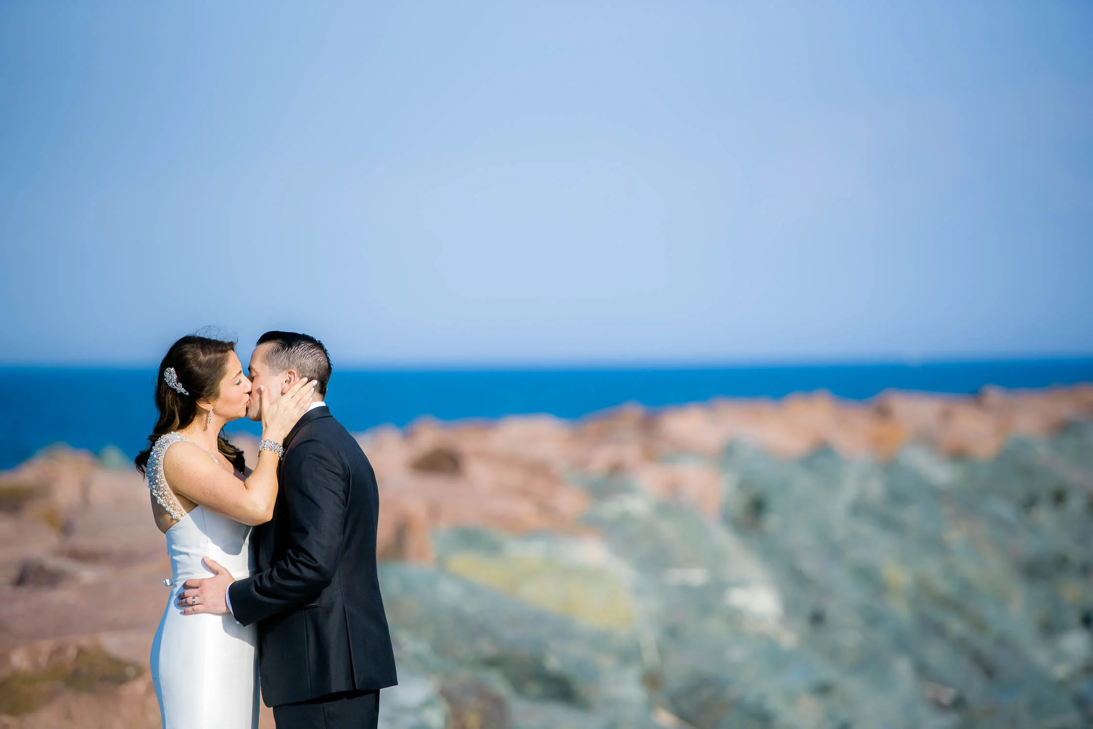Bride and groom share a kiss at the 31st Street Beach before their Bridgeport Art Center wedding in Chicago.