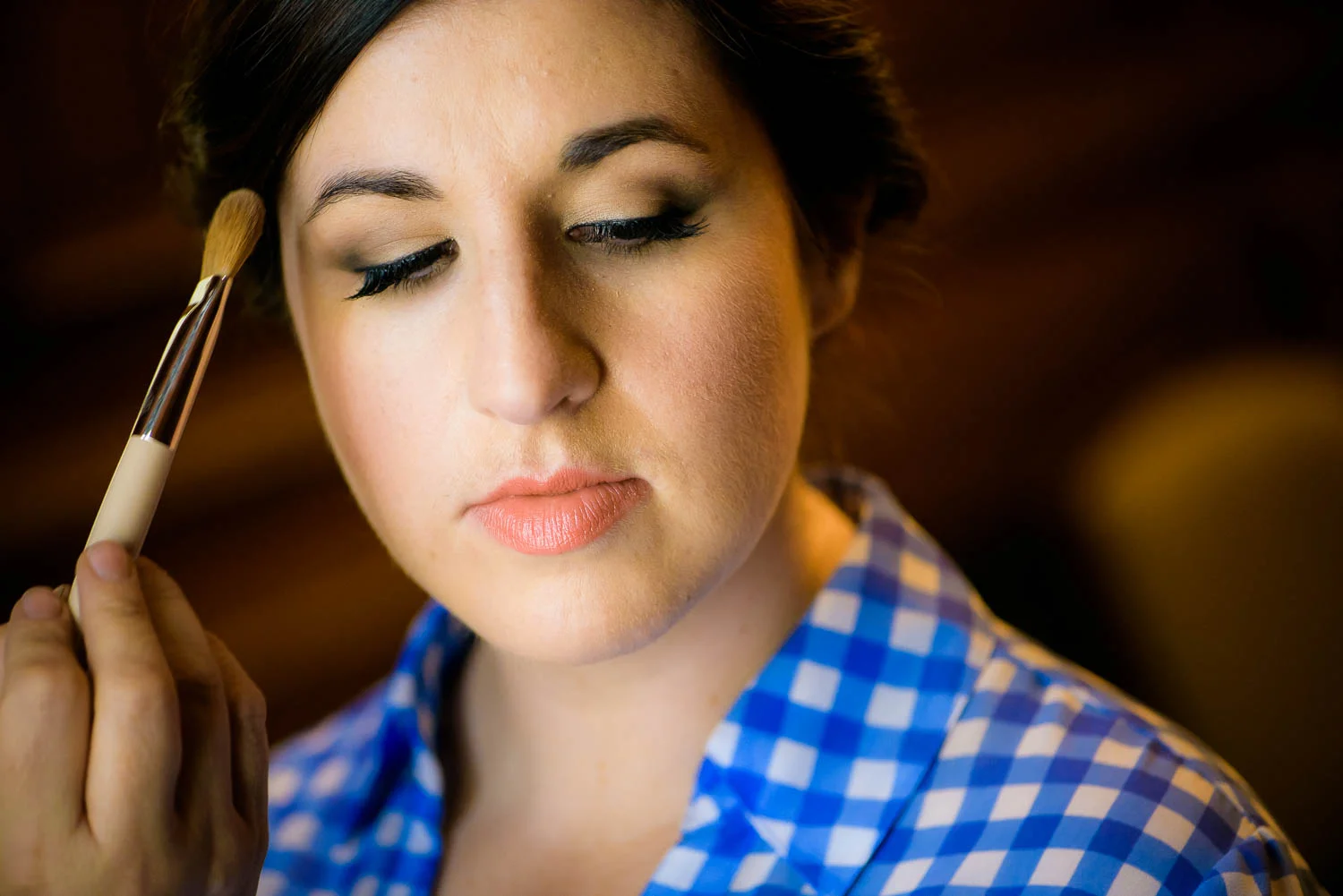 Bride getting ready before her Portrait of bride & groom in the Library at their University Club of Chicago wedding.