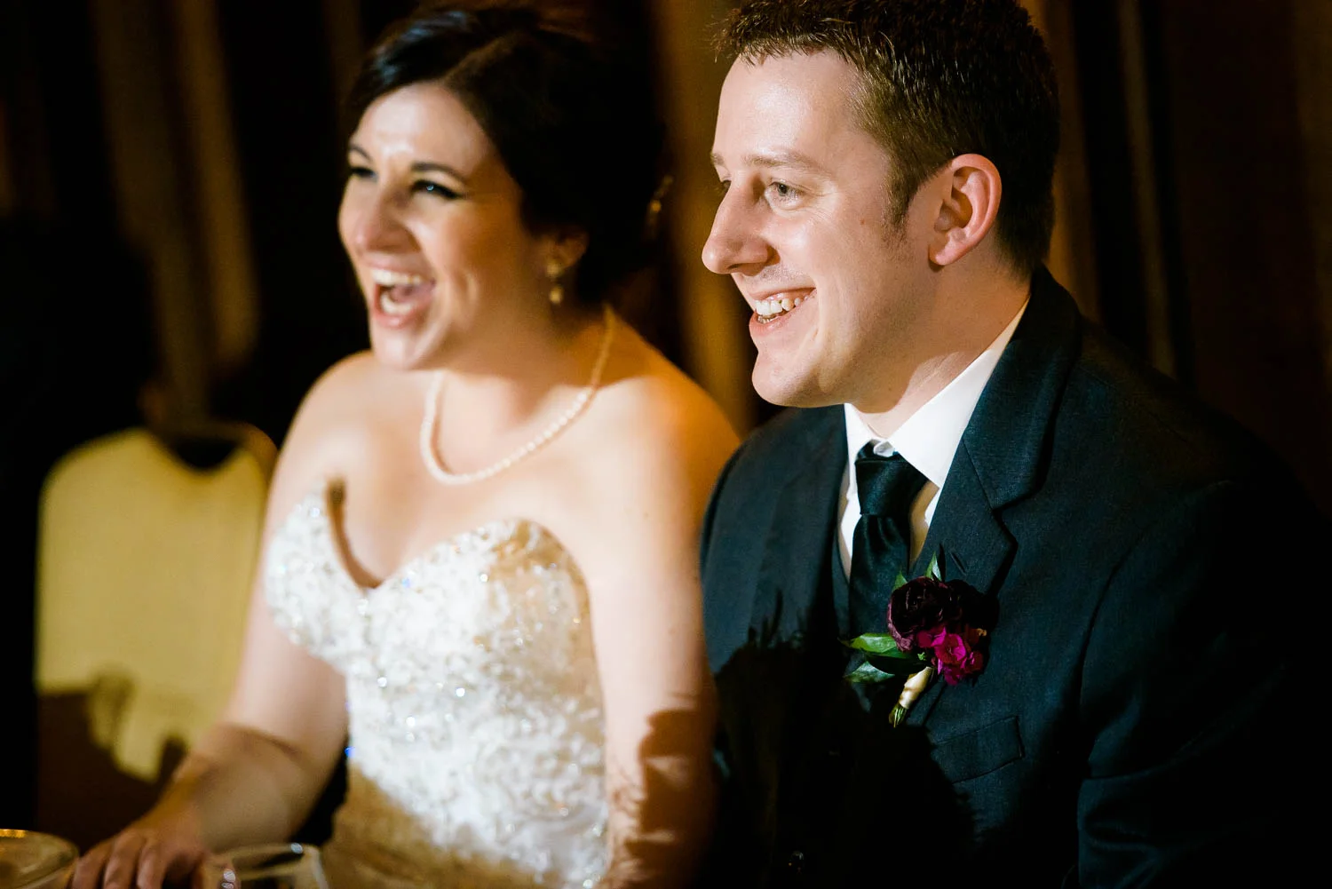 Couple laughs during their wedding party speeches during a University Club of Chicago wedding. 