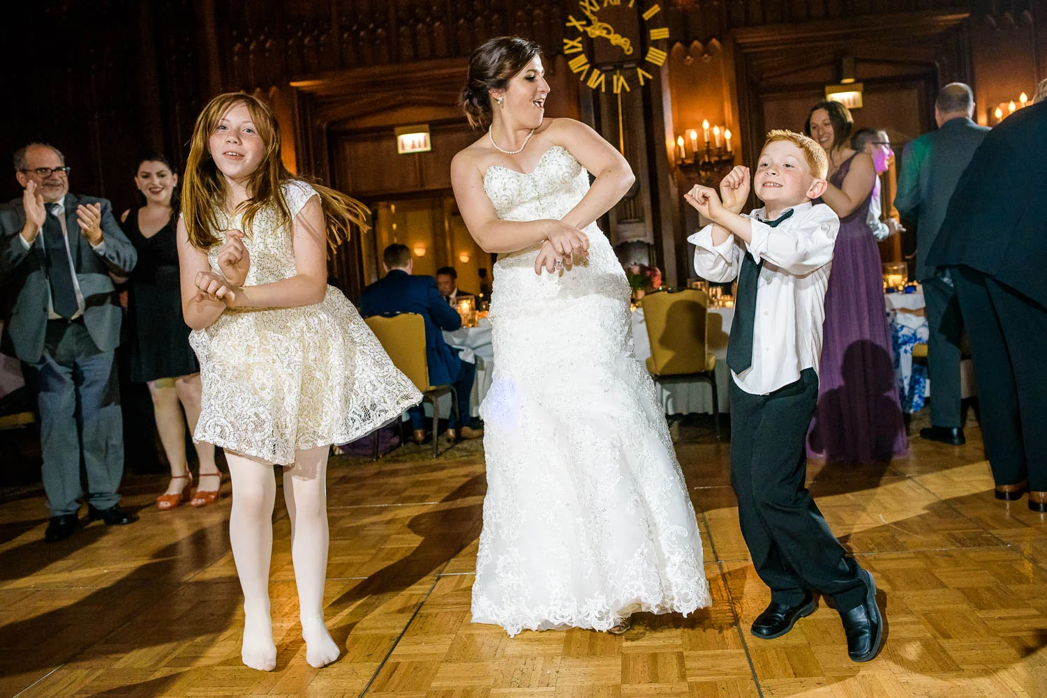 Bride dances with the flower girl and ring bearer during a University Club of Chicago wedding. 