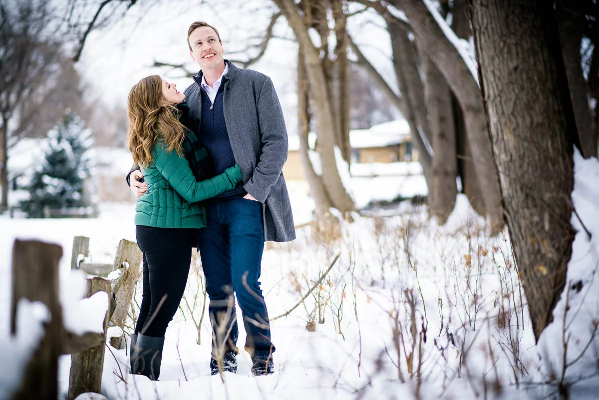 Lawrence & Katie joy embrace during their Chicago winter engagement session at Billy Caldwell Golf Course.