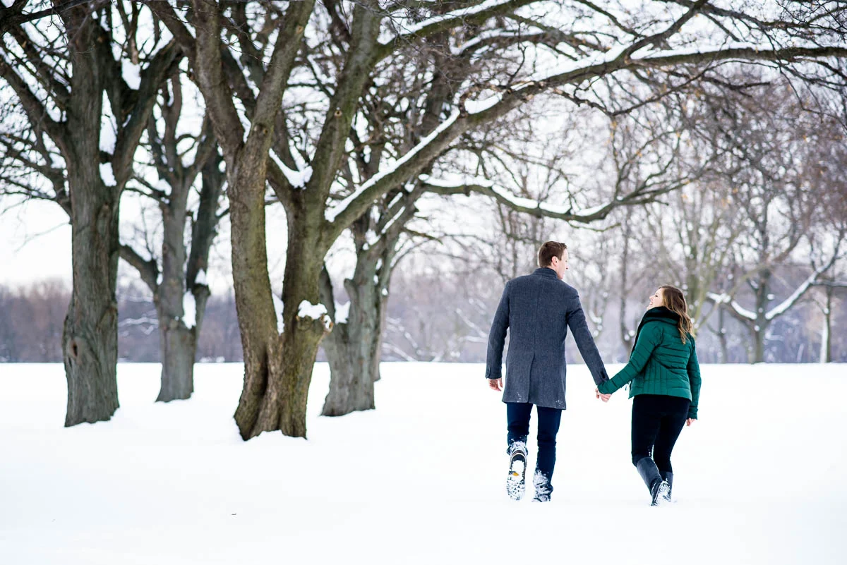 Lawrence & Katie joy embrace during their Chicago winter engagement session at Billy Caldwell Golf Course.