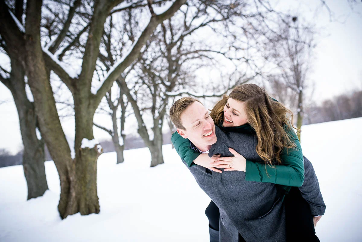 Lawrence & Katie joy embrace during their Chicago winter engagement session at Billy Caldwell Golf Course.