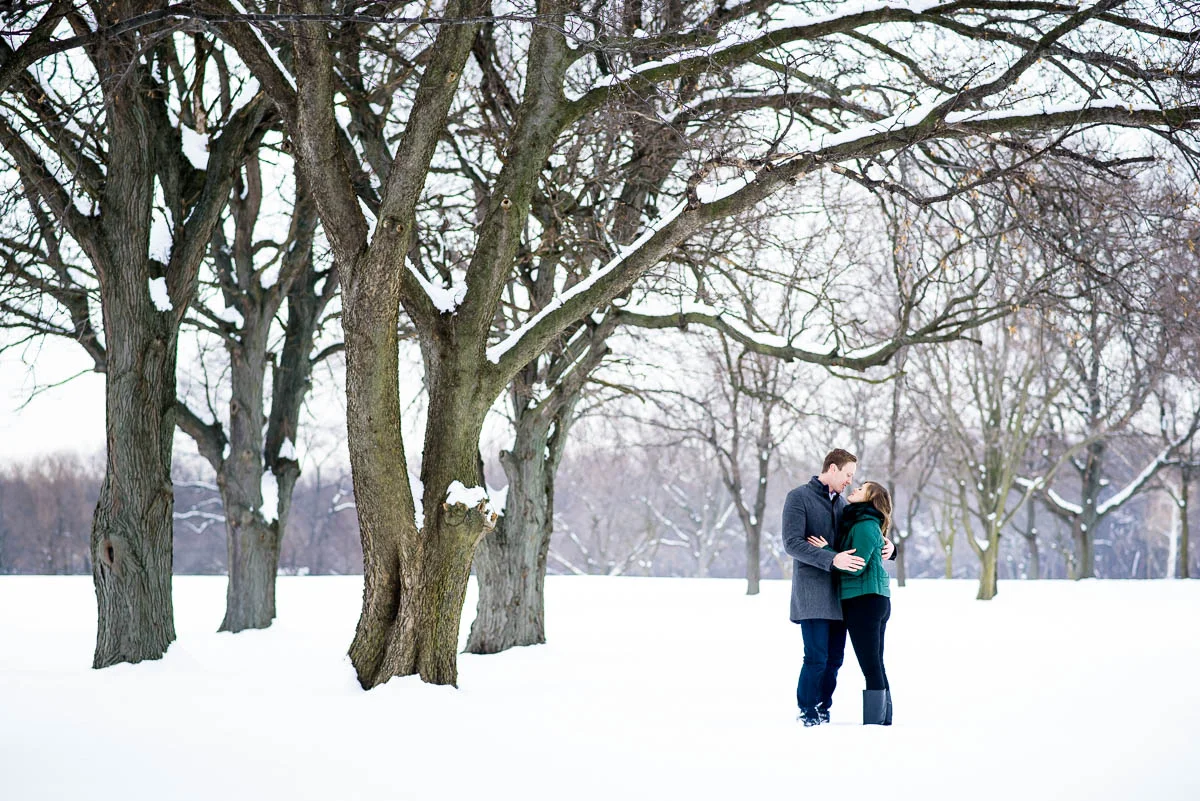 Lawrence & Katie joy embrace during their Chicago winter engagement session at Billy Caldwell Golf Course.