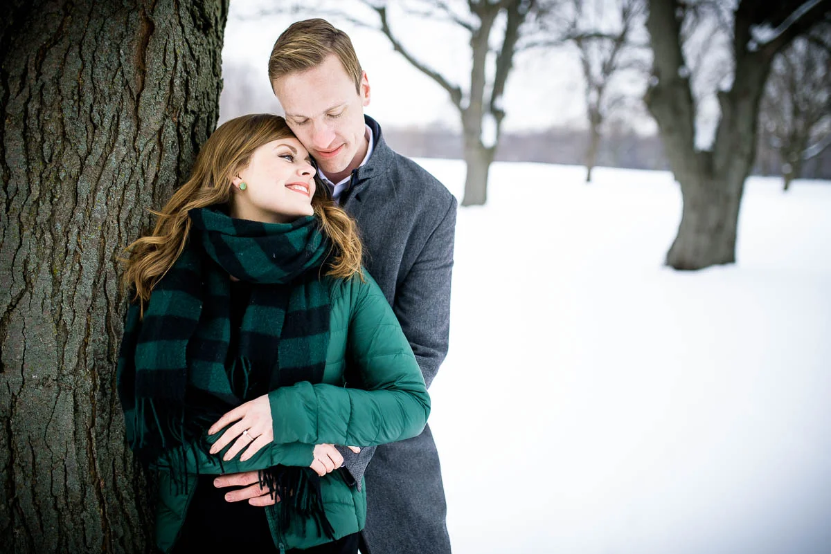Lawrence & Katie joy embrace during their Chicago winter engagement session at Billy Caldwell Golf Course.