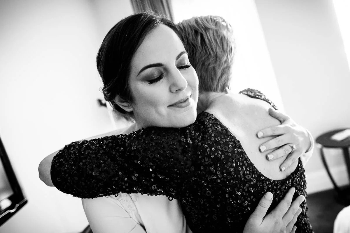 Bride and mom embrace at the Waldorf Astoria during her MCA Chicago winter wedding. 