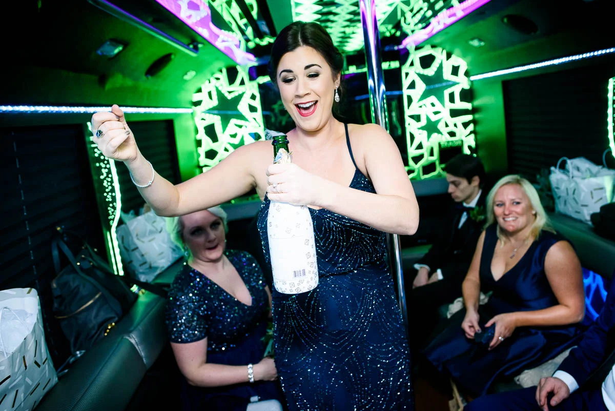 Popping the champagne on the way to the ceremony at St. James Chapel Chicago. 