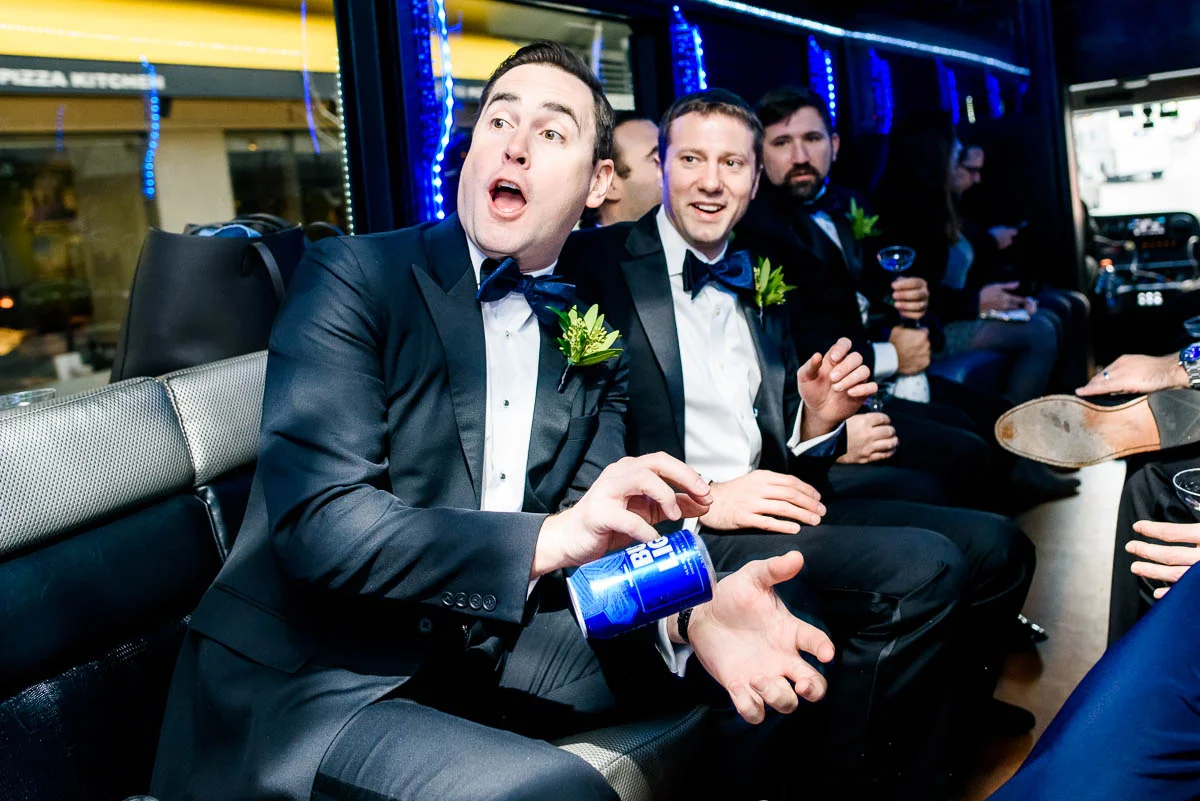 Groomsmen throwing beers to each other on the way to the ceremony at St. James Chapel Chicago. 