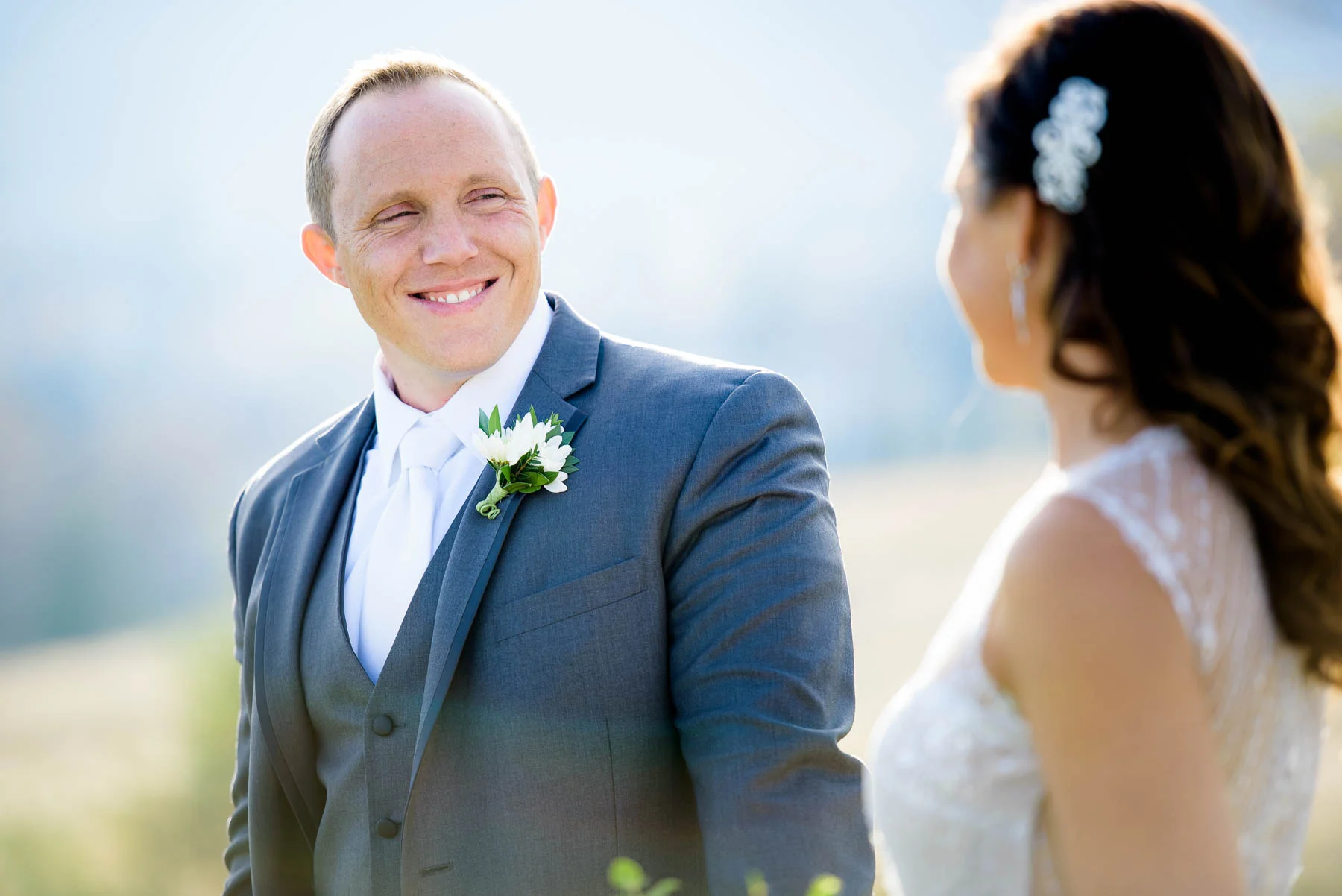 Groom looks at the bride during their wedding day at the Manor House in Littleton, Colorado. 