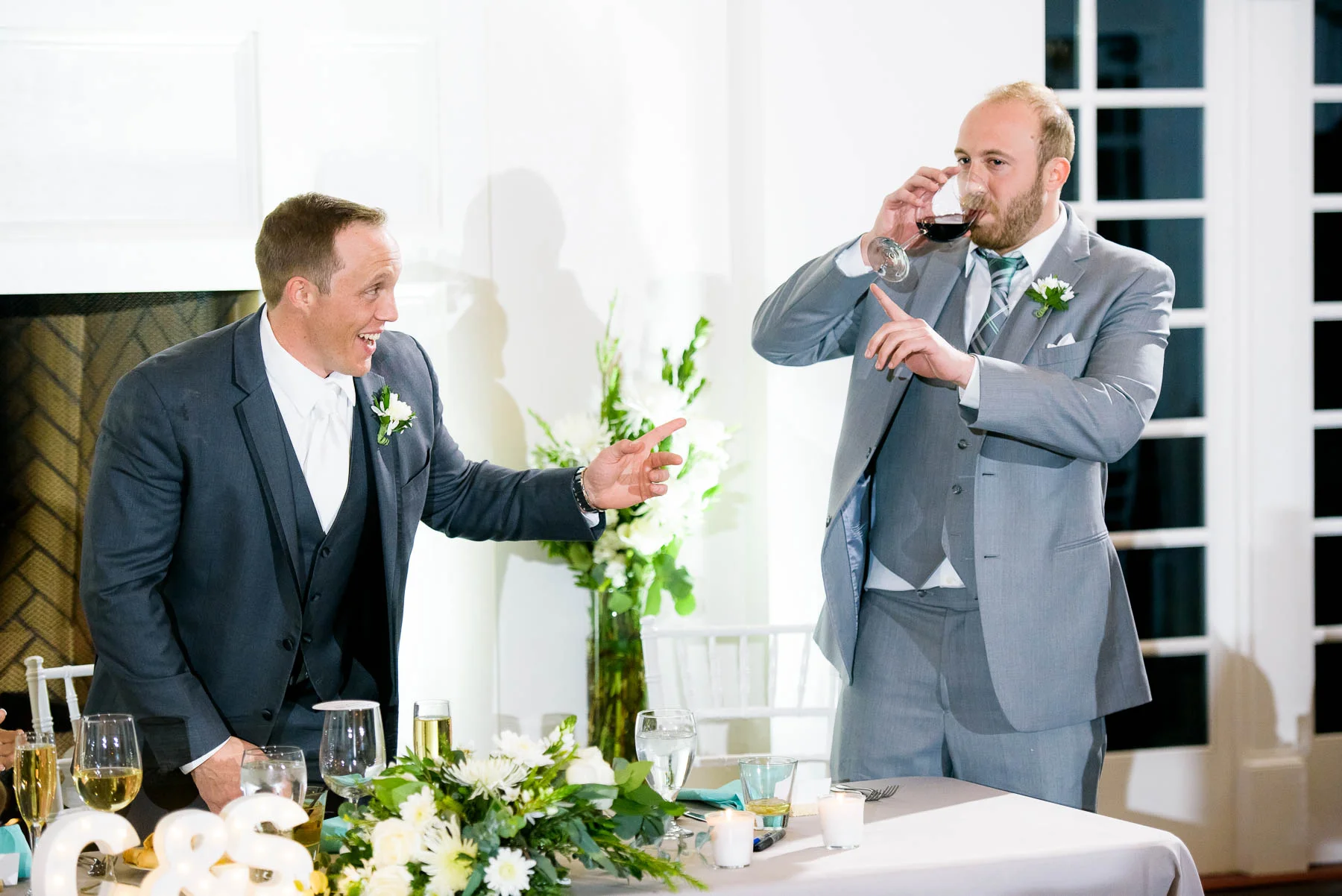 Funny moment between groom and best-man during a wedding at the Manor House in Littleton, Colorado.