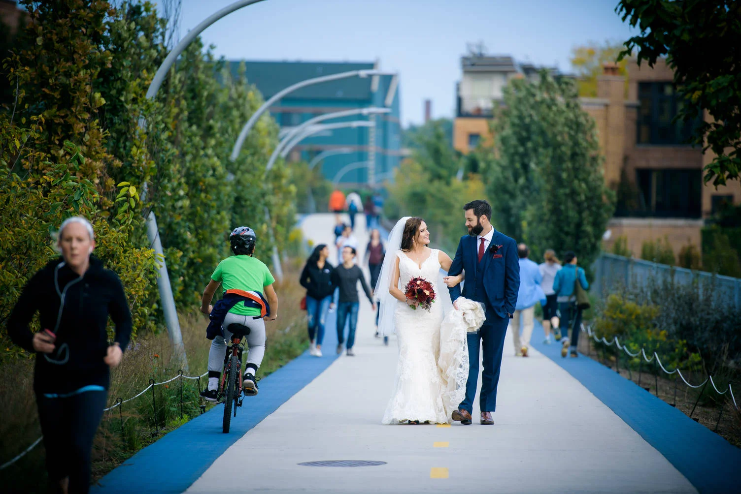 Bride and groom walk down the 606 trail during their Logan Square wedding in Chicago. 