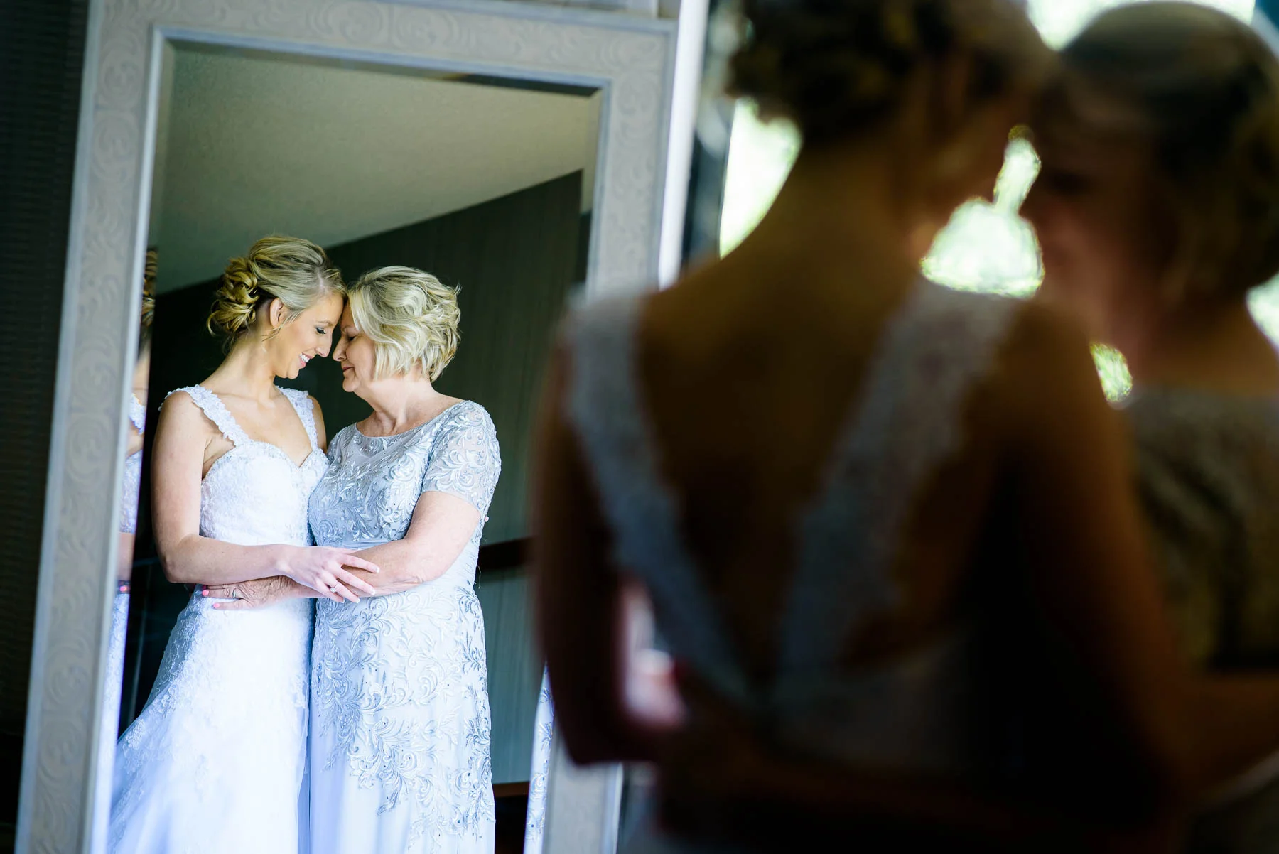 Tender emotional moment between mother and bride before a St. Charles Country Club wedding. 