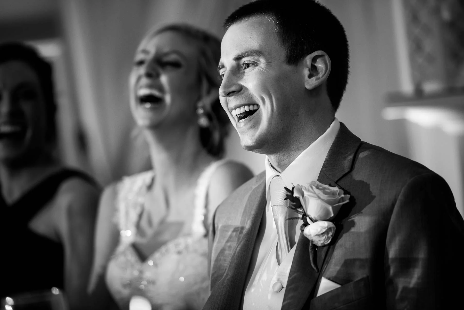 The couple laughs with the best men during their St. Charles Country Club wedding. 