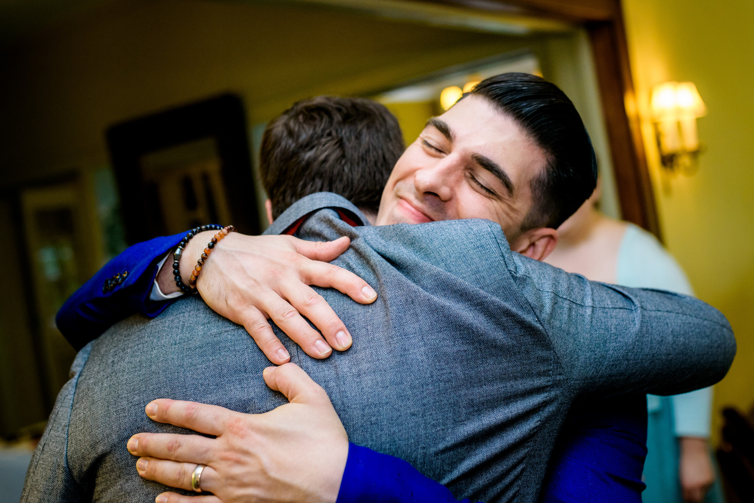 Groom gets a hug during a Cheney Mansion wedding in Oak Park. 