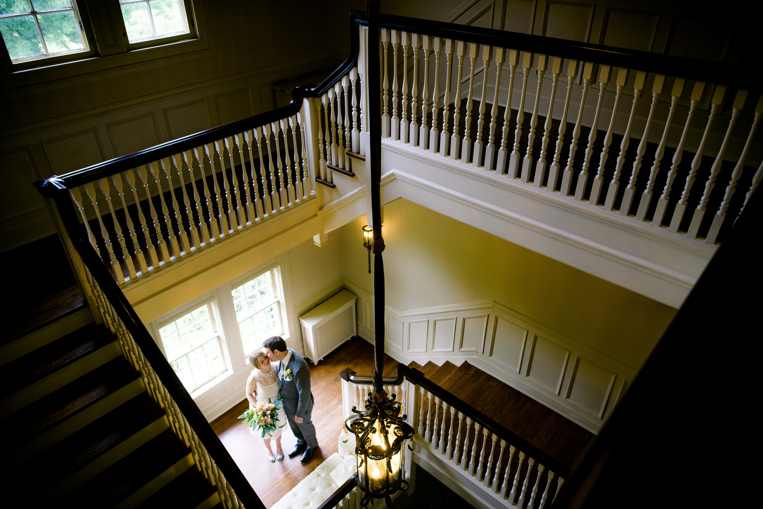 Indoor grand staircase portrait of the couple during a Cheney Mansion wedding in Oak Park. 
