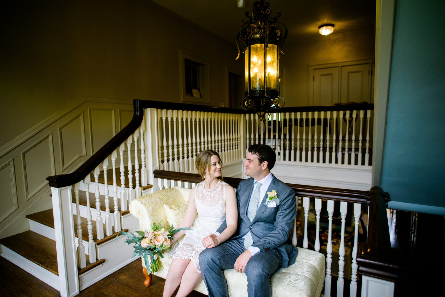 Grand staircase portrait of the couple during a Cheney Mansion wedding in Oak Park. 