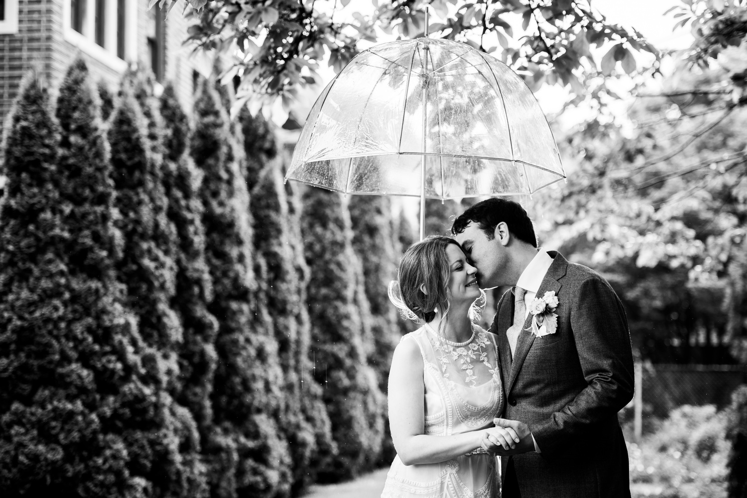 Outdoor rainy day portrait of the bride and groom during a Cheney Mansion wedding in Oak Park. 