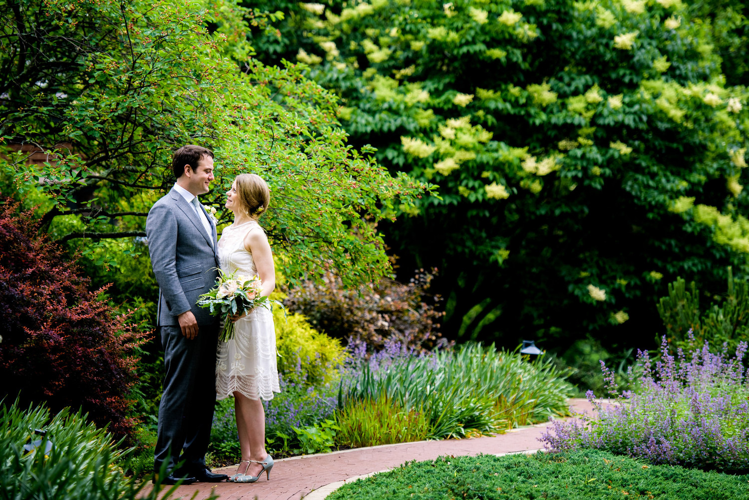 Photo of bride and groom in the gardens during a Cheney Mansion wedding in Oak Park. 