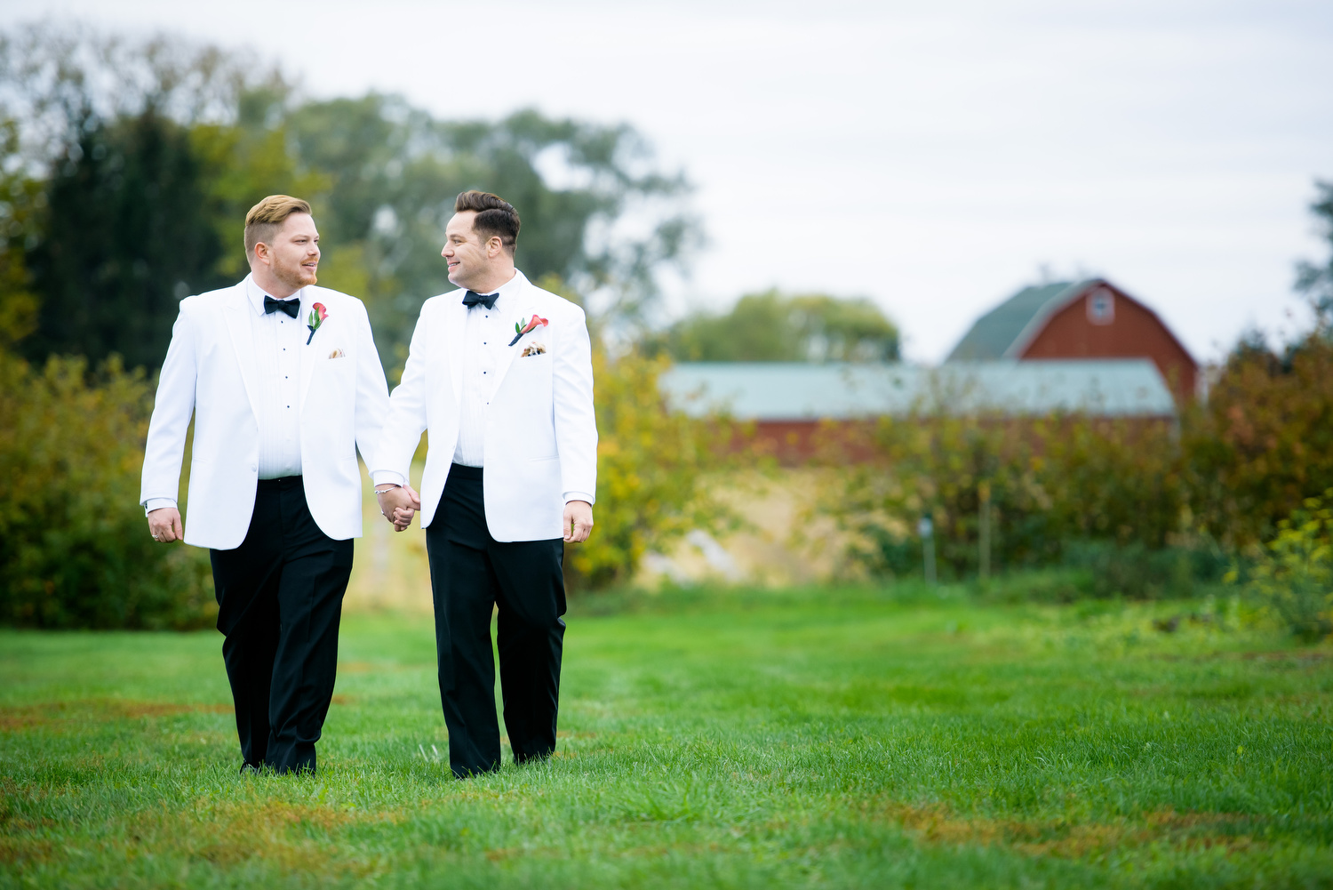 Portrait of the grooms at Heritage Prairie Farm during their wedding. 