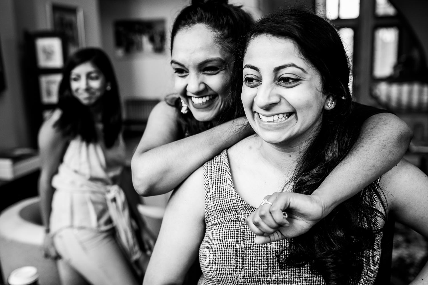 Bridesmaids watch the bride getting her henna put on during an Indian wedding mehndi in South Barrington, Illinois.