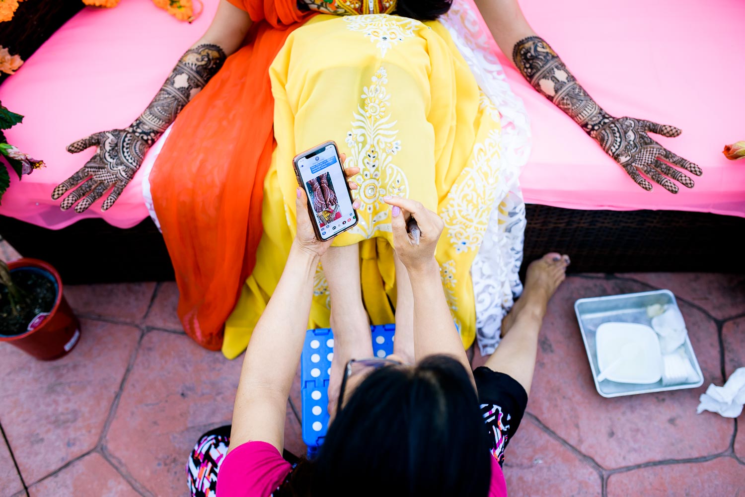 Henna artist, Henna Moments, during an Indian wedding mehndi in South Barrington, Illinois.
