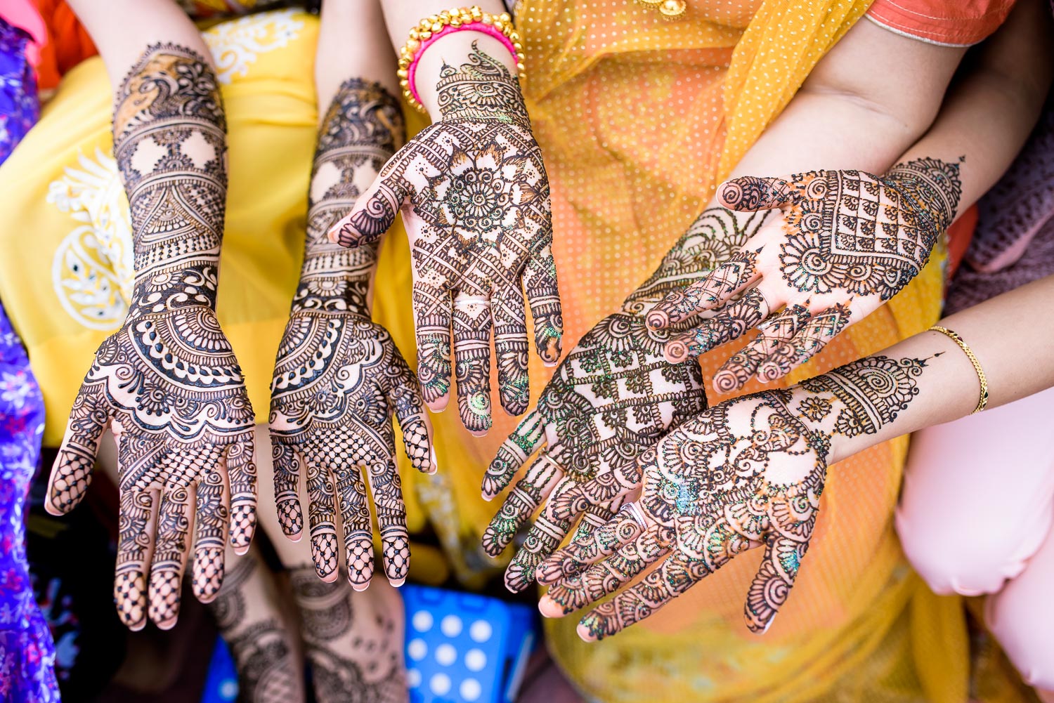 Bride, sister and mother of bride henna during an Indian wedding mehndi in South Barrington, Illinois.