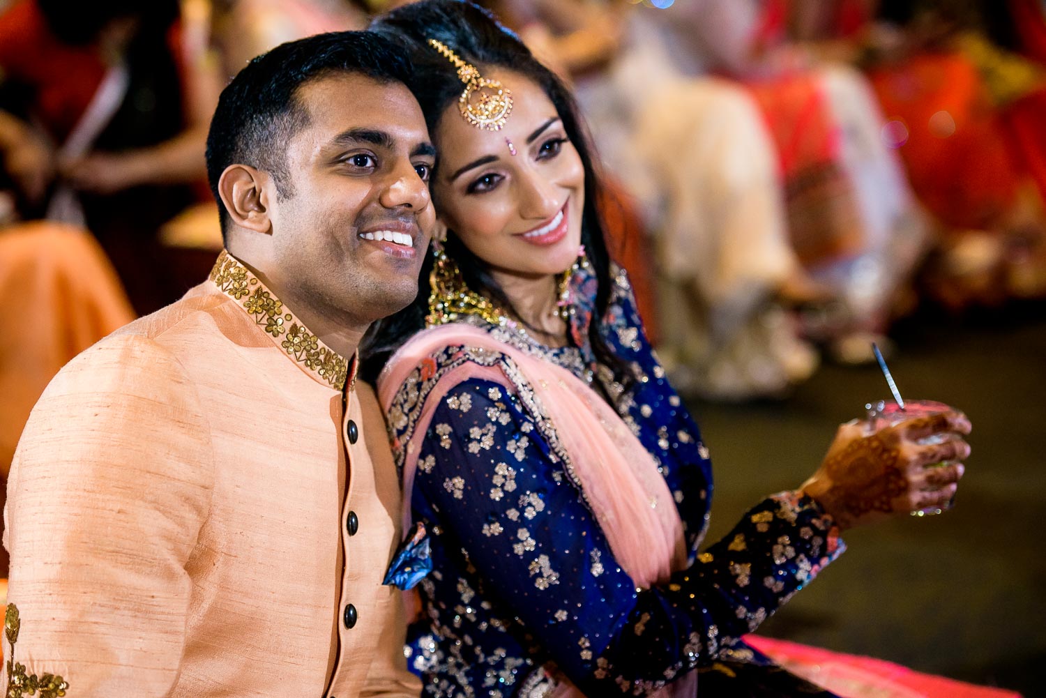 Bride and groom watch the performances during an Indian wedding sangeet at Stonegate Banquets in Hoffman Estates. 
