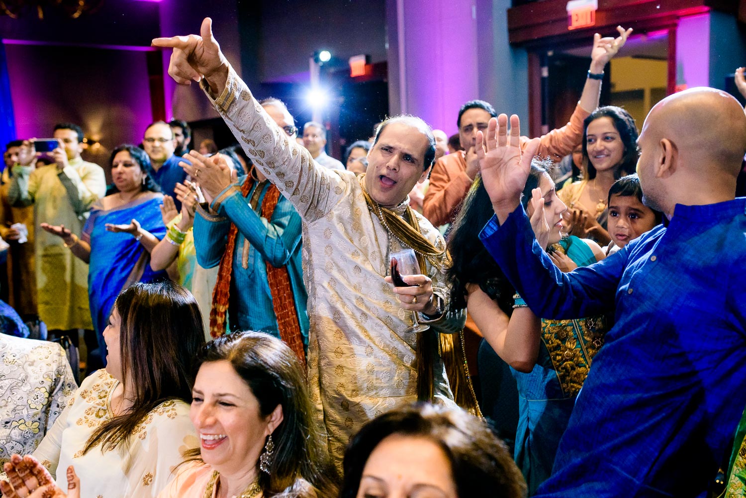 The crowd celebrates during an Indian wedding sangeet at Stonegate Banquets in Hoffman Estates. 