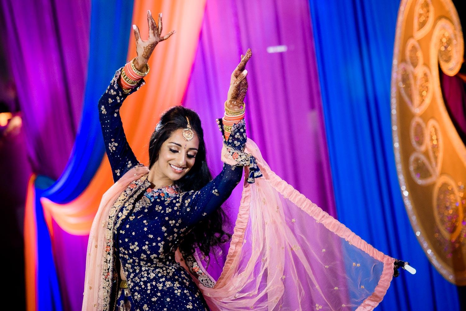 The bride dances during an Indian wedding sangeet at Stonegate Banquets in Hoffman Estates. 