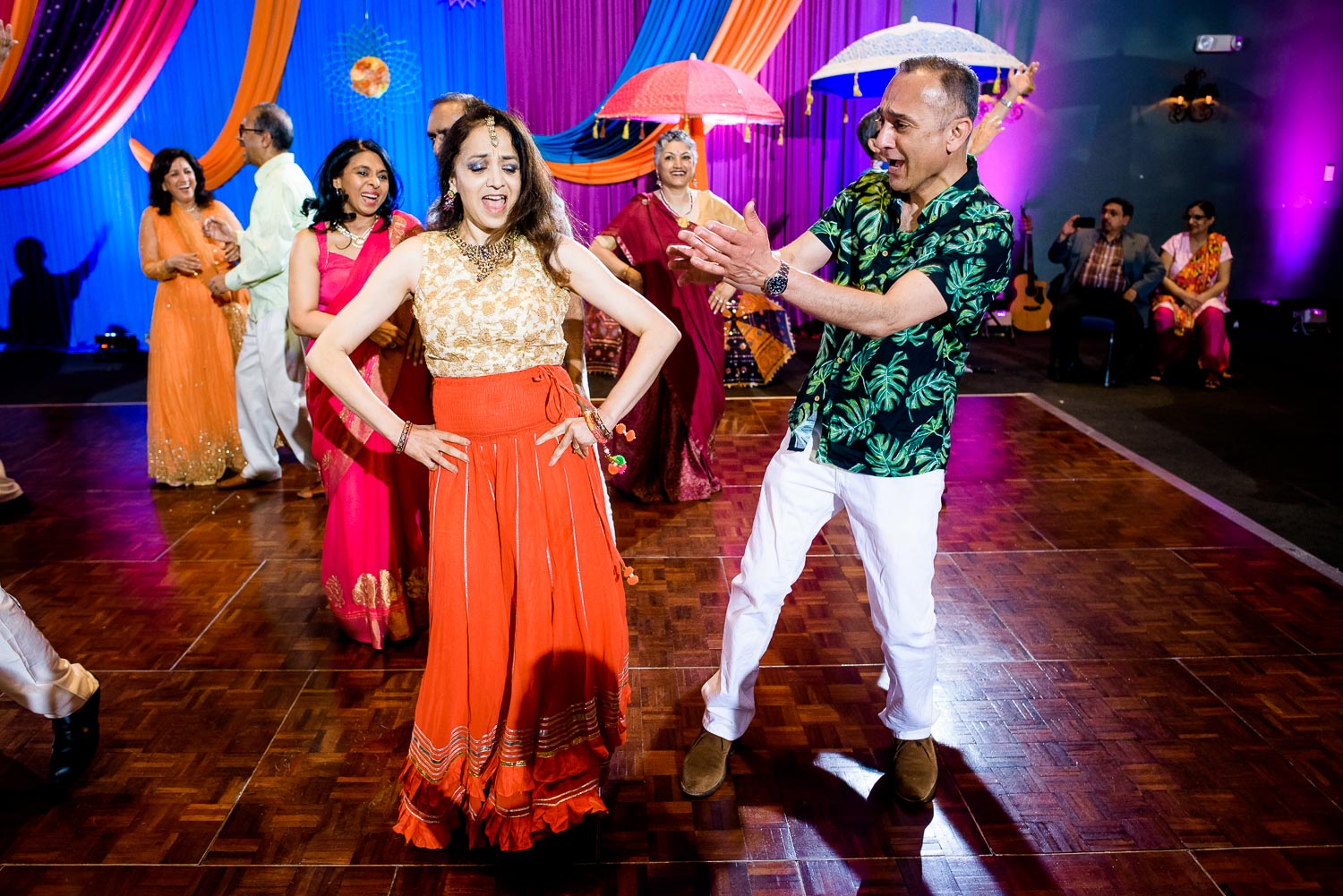 Aunts and uncles dance during an Indian wedding sangeet at Stonegate Banquets in Hoffman Estates. 