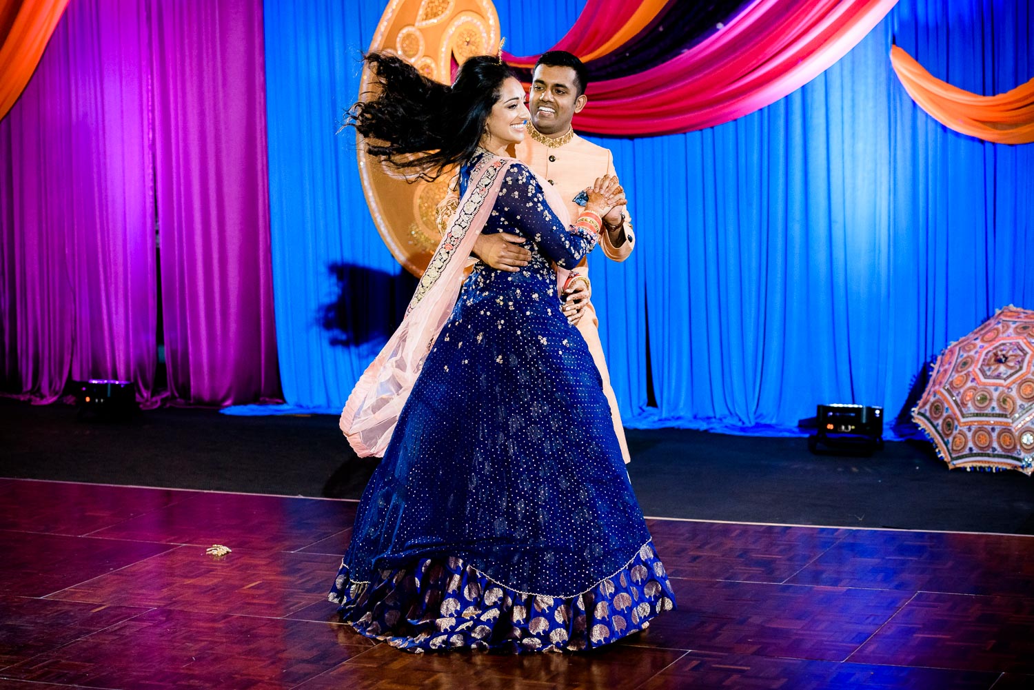 Bride and groom dance during an Indian wedding sangeet at Stonegate Banquets in Hoffman Estates.