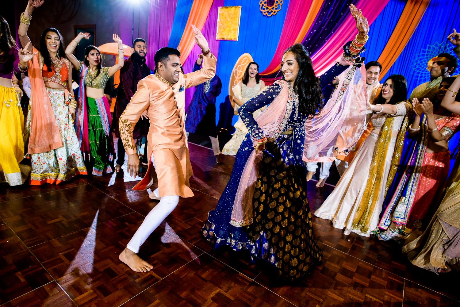 Couple and wedding party dance during an Indian wedding sangeet at Stonegate Banquets in Hoffman Estates. 