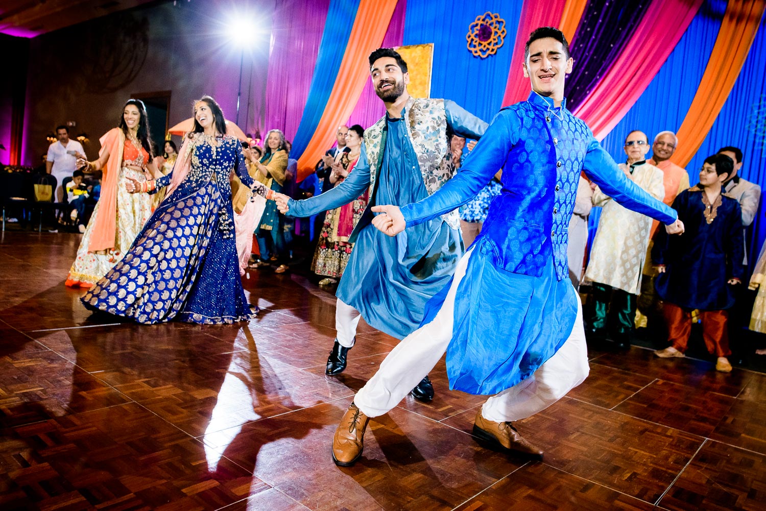 Bride and siblings dance during an Indian wedding sangeet at Stonegate Banquets in Hoffman Estates.
