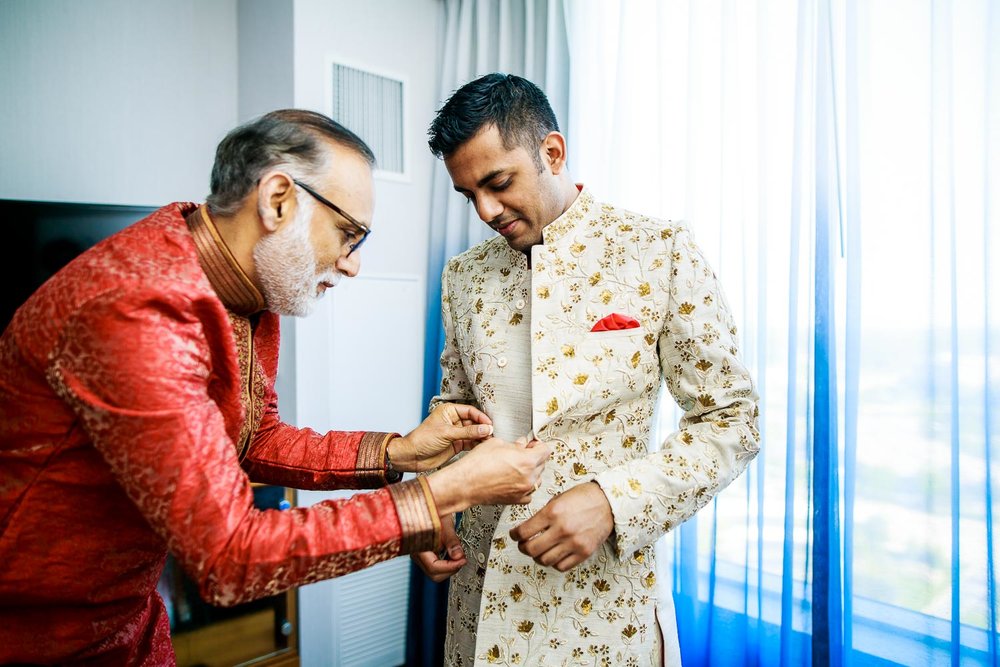 Groom getting ready during a Renaissance Schaumburg Convention Center Indian wedding.