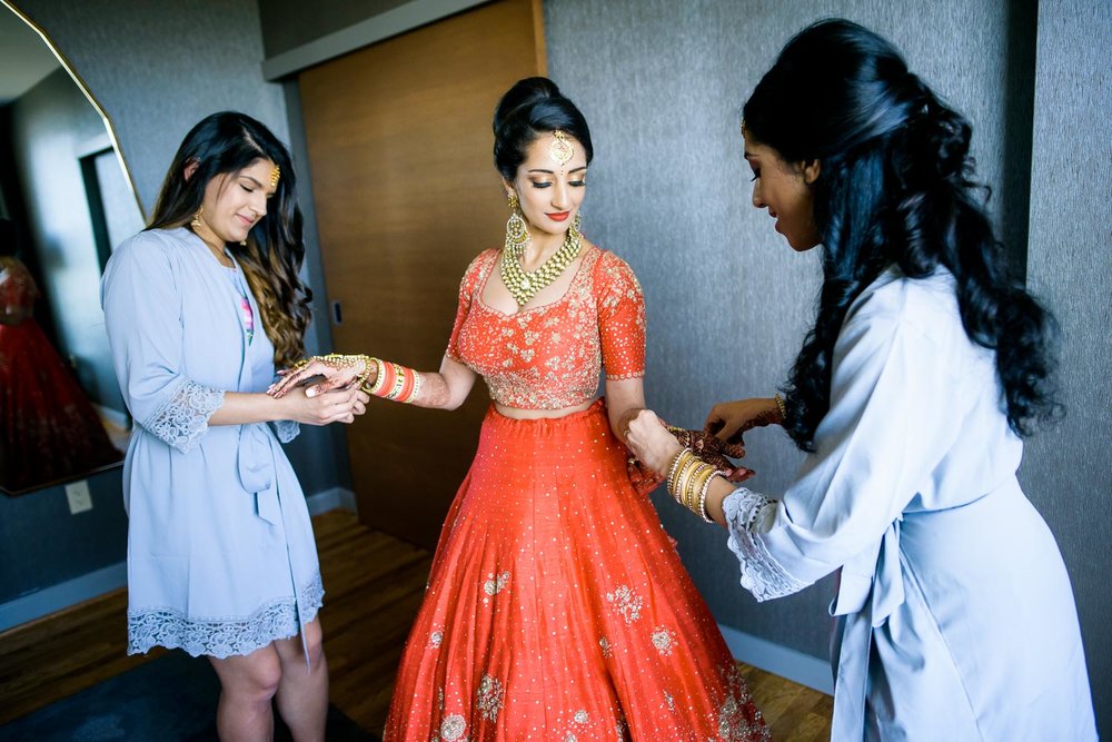 Bride getting ready with bridesmaids during a Renaissance Schaumburg Convention Center Indian wedding.