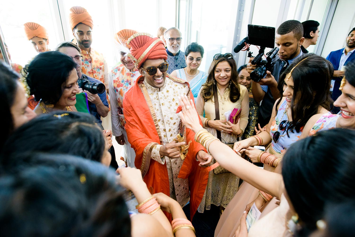 Grooms shoes buying at a Renaissance Schaumburg Convention Center Indian wedding.