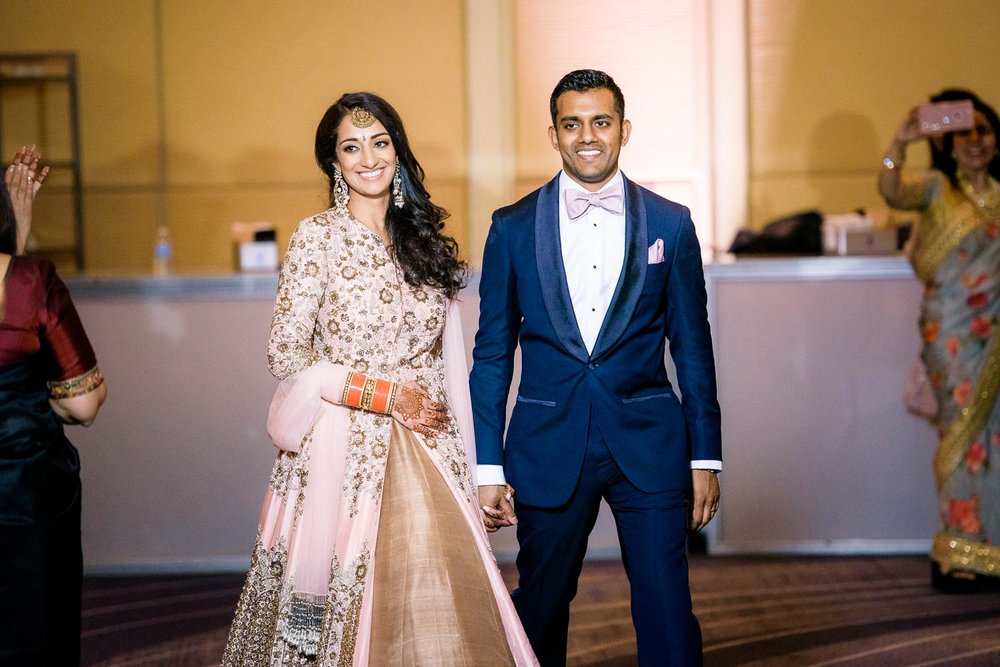 Bride and groom introductions during a Renaissance Schaumburg Convention Center Indian wedding reception.