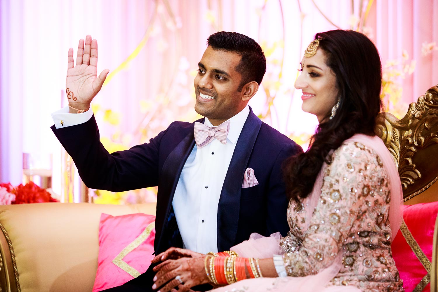 Father and bride share a laugh during a Renaissance Schaumburg Convention Center Indian wedding reception.