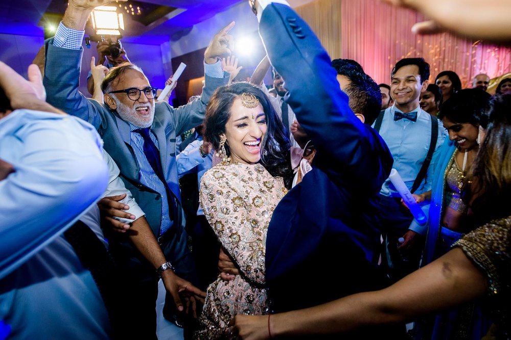 Funny dancing photo during a Renaissance Schaumburg Convention Center Indian wedding reception.