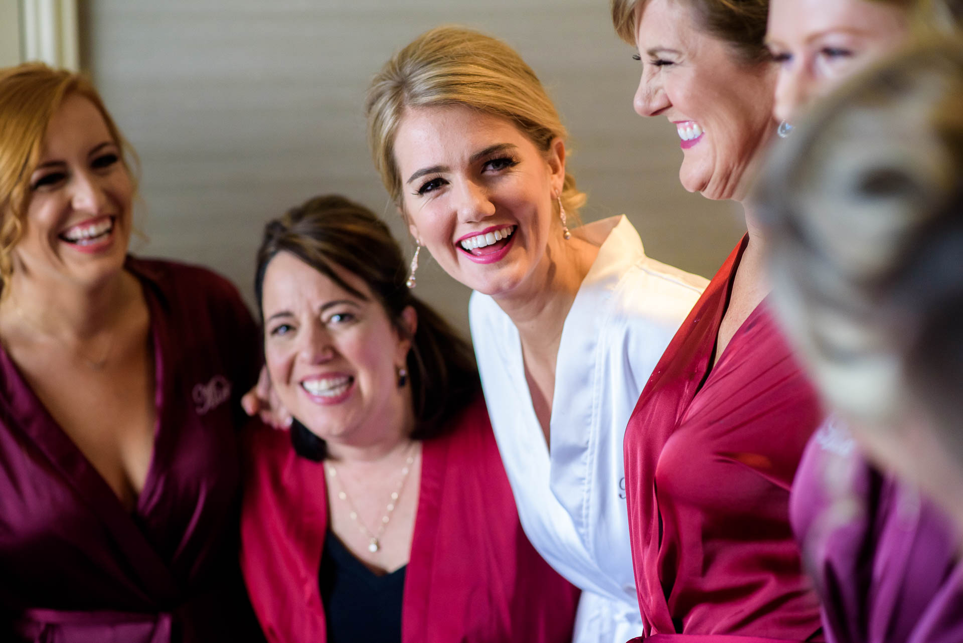 Bride and bridesmaids share a laugh before a Mid America Club wedding Chicago.