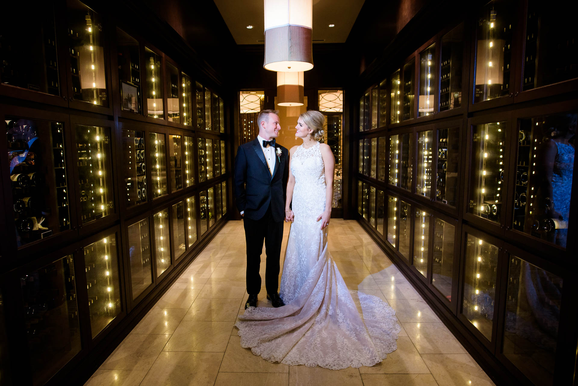 Creative wedding photo of bride and groom inside the wine cellar at the Mid America Club in Chicago.