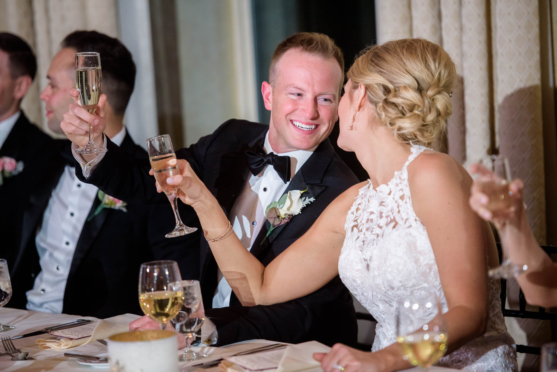 Couple toast during their wedding reception at the Mid America Club in Chicago.