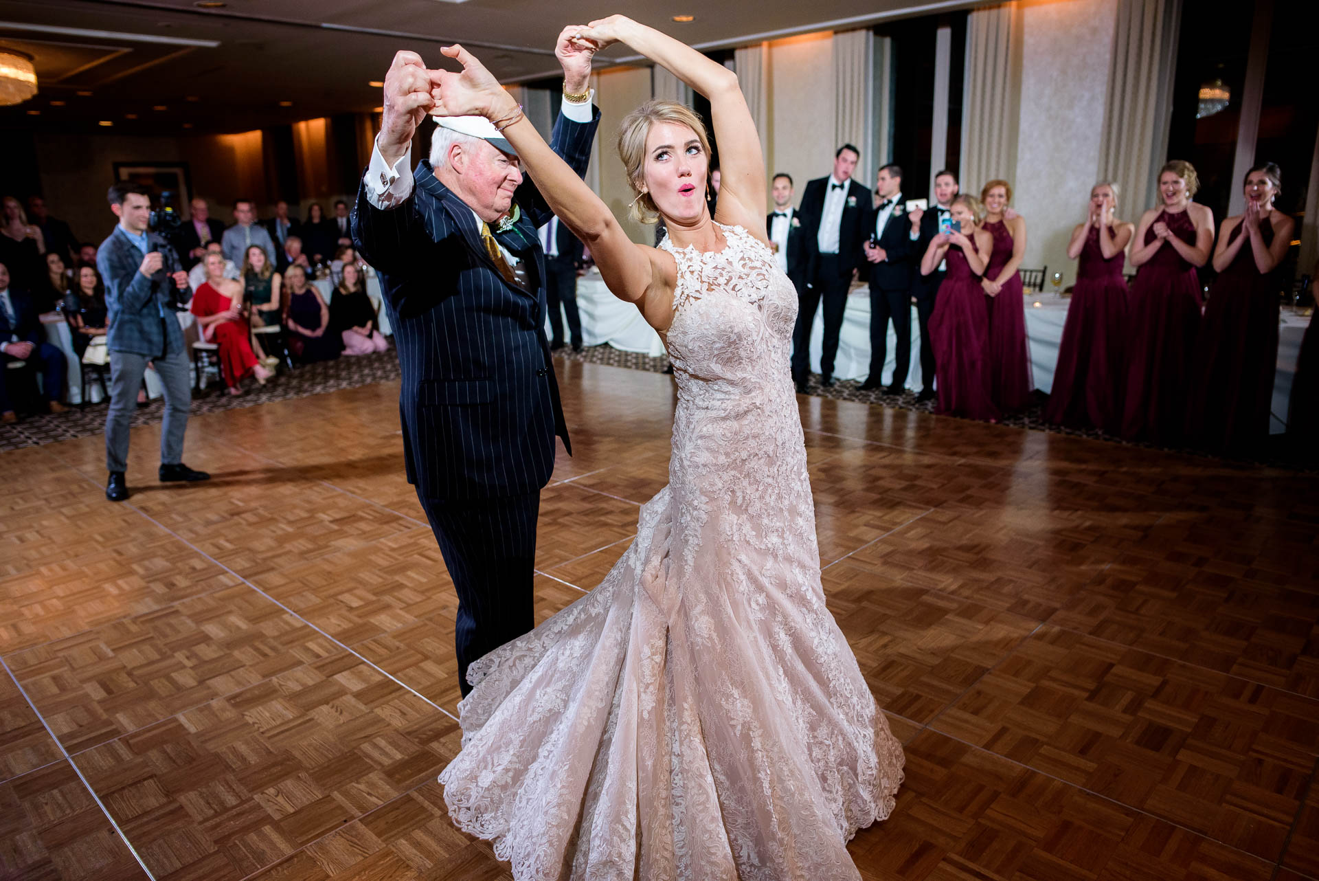 Bride and uncle dance during a wedding reception at the Mid America Club in Chicago.