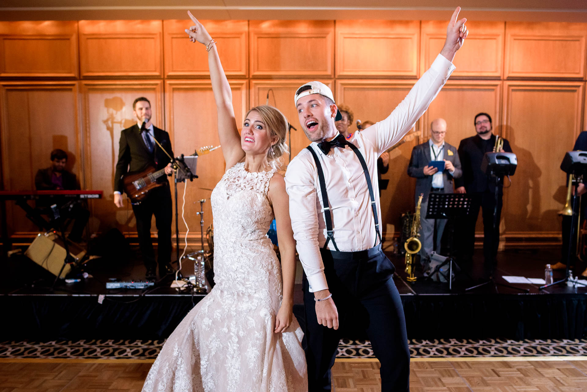 Bride and brother dance during a wedding reception at the Mid America Club in Chicago.