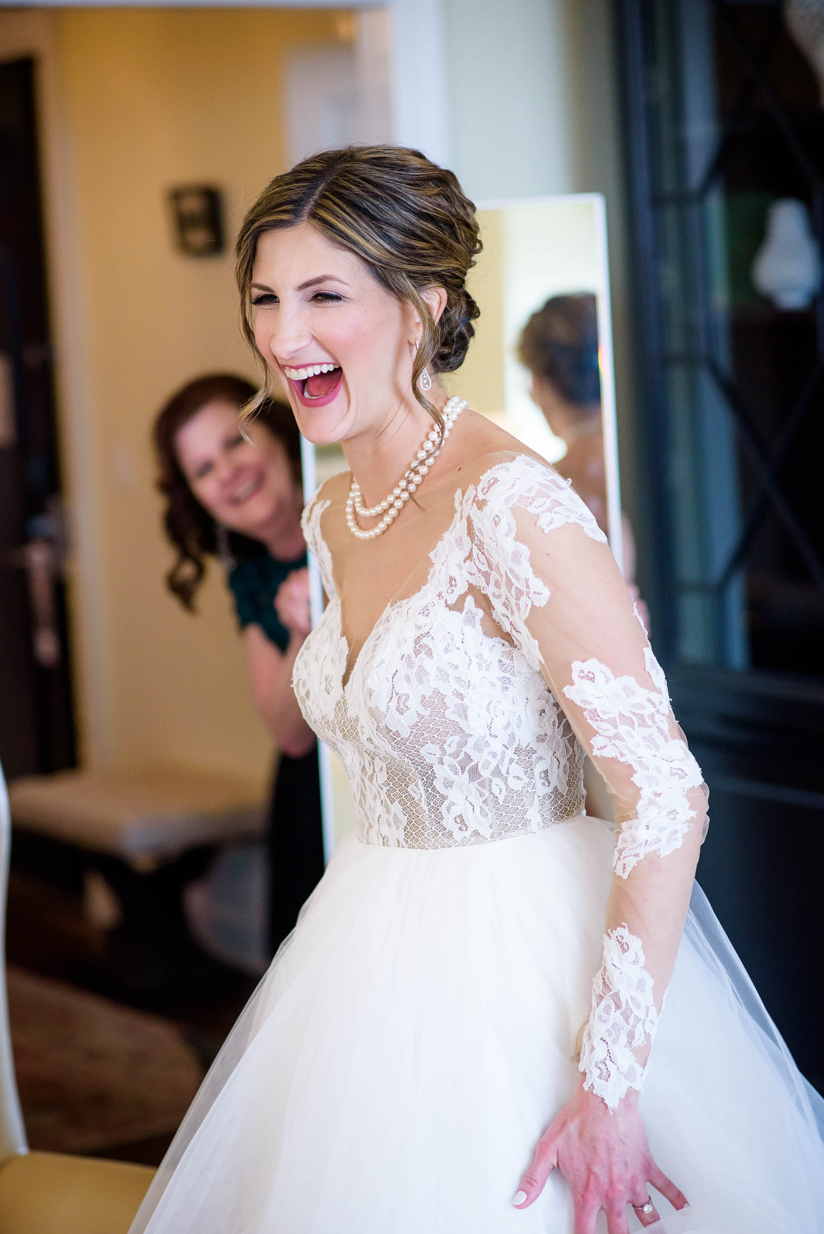 Bride laughs while getting ready during a Blackstone Chicago wedding.