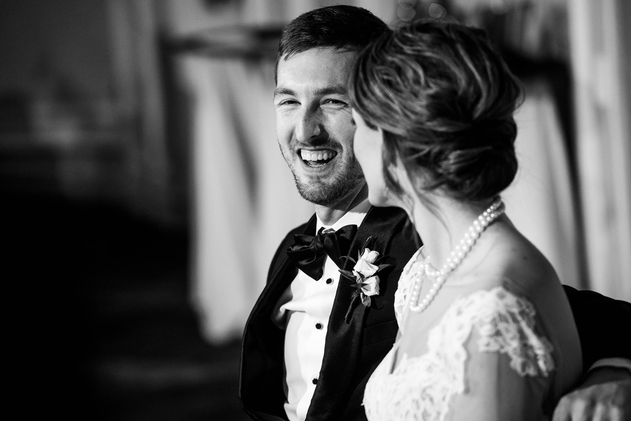 Groom reacts to the father of the bride during a Blackstone Chicago wedding.