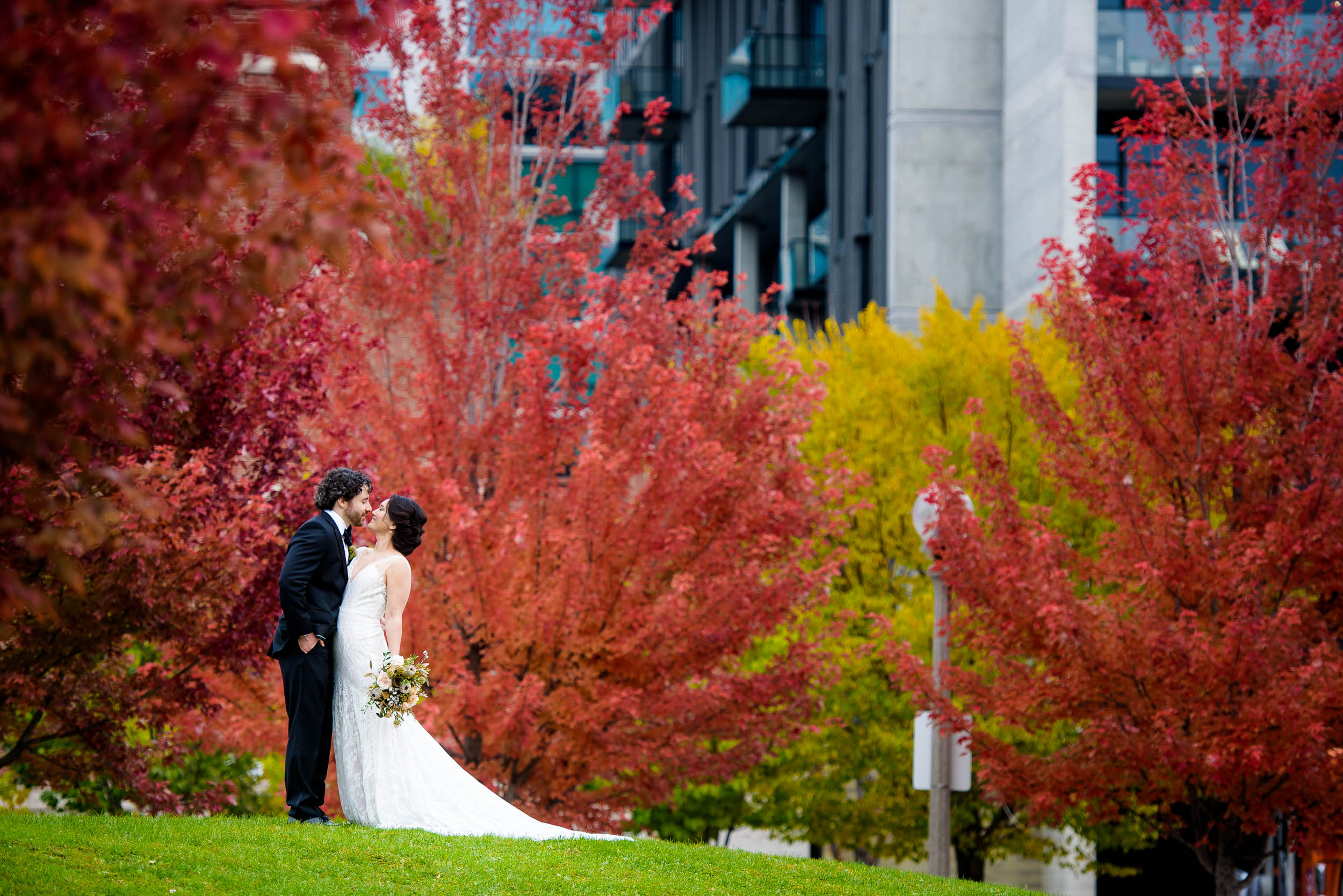 Bride and groom kiss amongst the fall colors at Mary Bartelme Park.