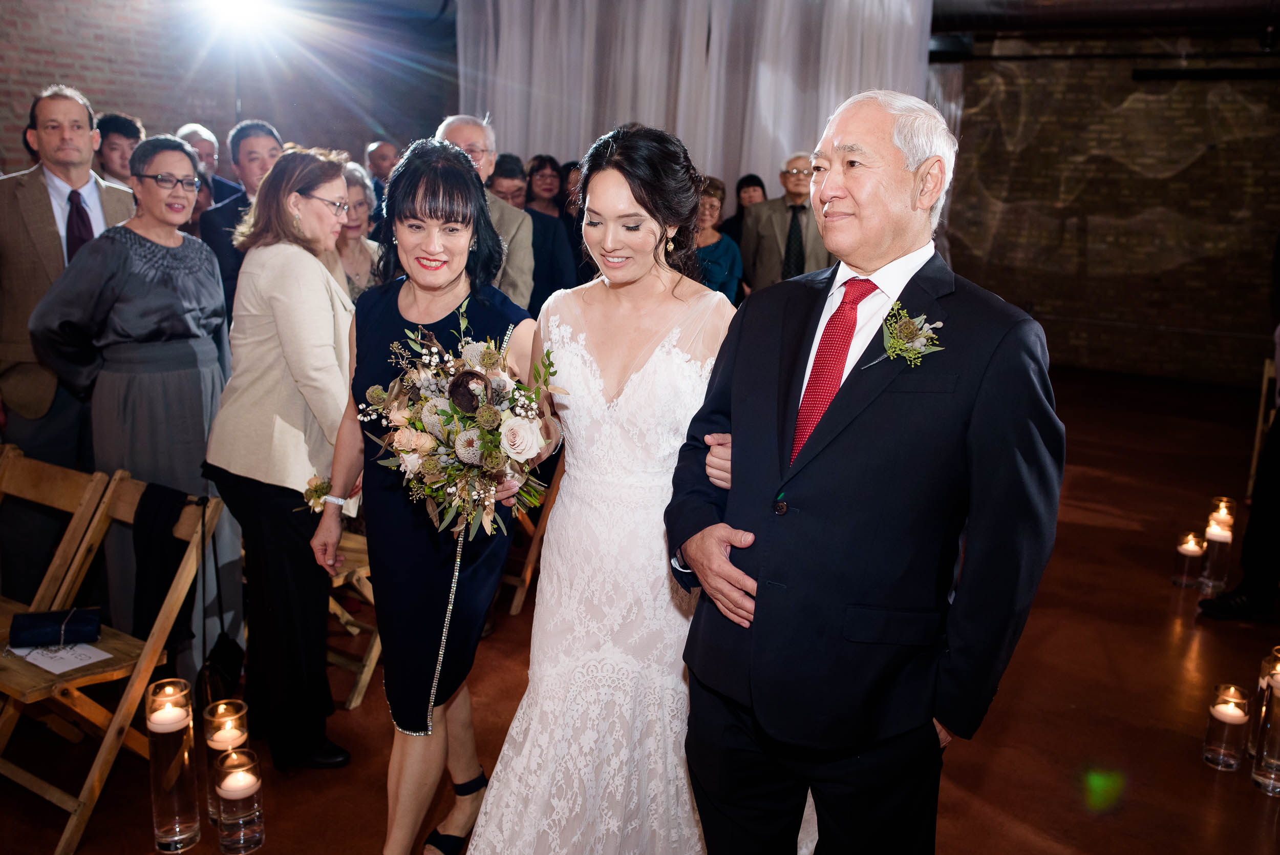 Bride and parents walk down the aisle during her Loft on Lake Chicago wedding.